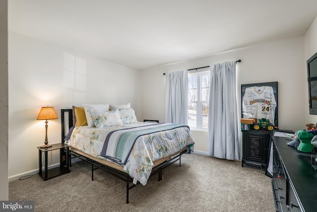 bedroom featuring light carpet and baseboards