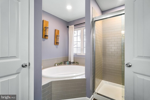 full bath featuring a shower stall and a bath