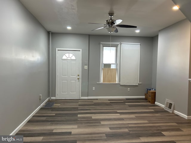 foyer featuring wood finished floors, visible vents, and baseboards