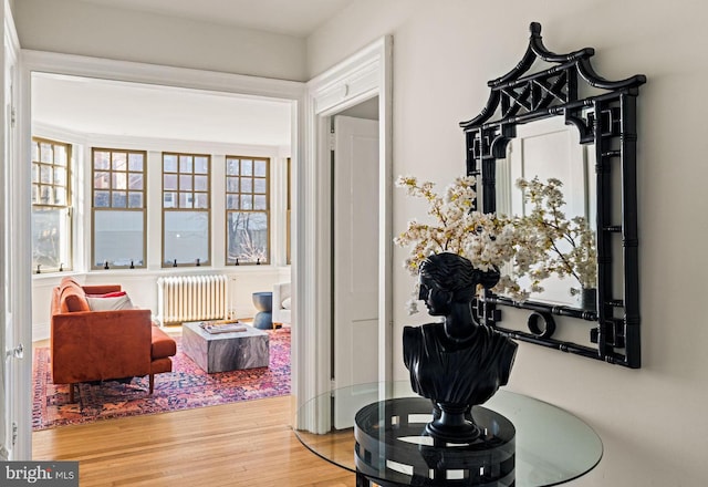 interior space featuring radiator and wood finished floors