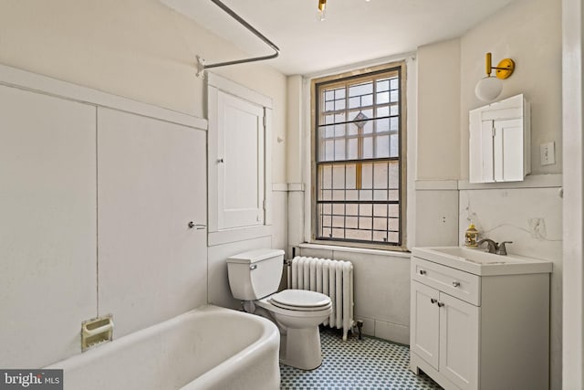 bathroom featuring toilet, radiator heating unit, shower / bathtub combination, and vanity