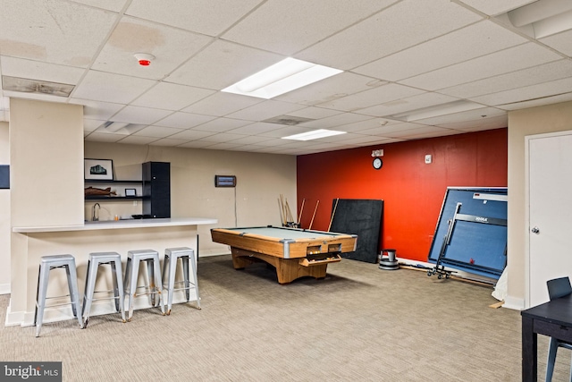 playroom with a paneled ceiling and light colored carpet