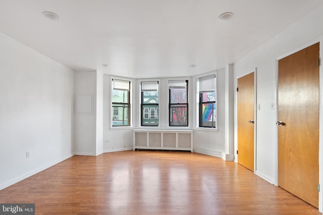 709 E Passyunk Ave, Philadelphia, PA 19147 - spare room featuring radiator, light wood-style flooring, and baseboards