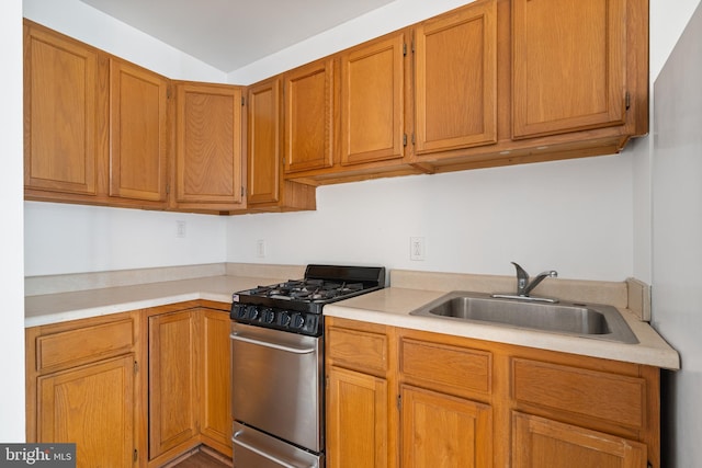 709 E Passyunk Ave, Philadelphia, PA 19147 - kitchen with a sink, brown cabinets, light countertops, and stainless steel range with gas stovetop