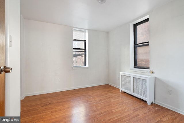 709 E Passyunk Ave, Philadelphia, PA 19147 - empty room with light wood-style floors, radiator heating unit, and baseboards