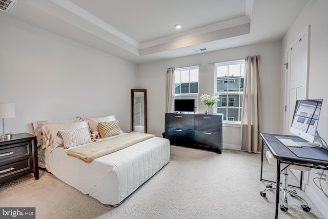 bedroom featuring baseboards, a raised ceiling, visible vents, and light colored carpet