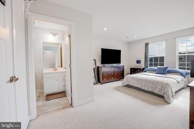 bedroom with baseboards, recessed lighting, a sink, and light colored carpet