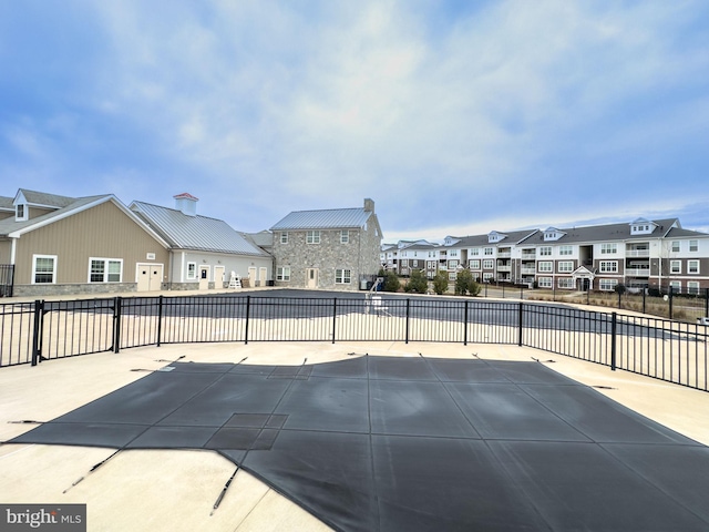 view of patio / terrace with a residential view and fence