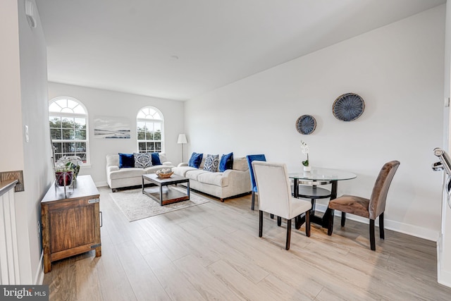 living area featuring light wood-type flooring and baseboards