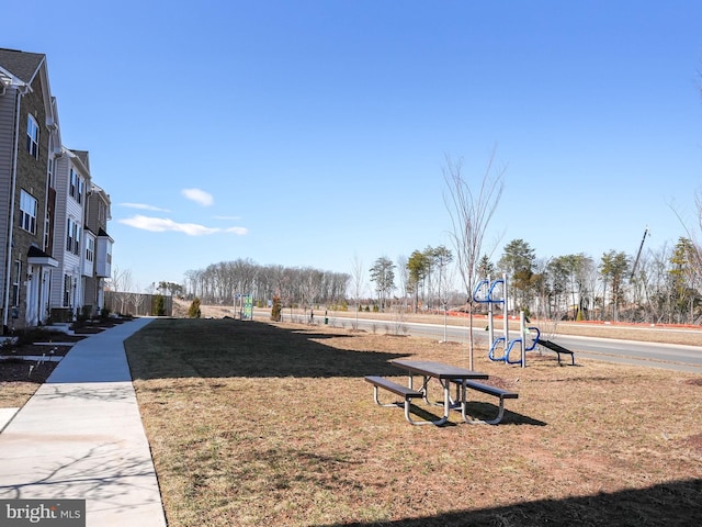 view of community featuring playground community and a lawn