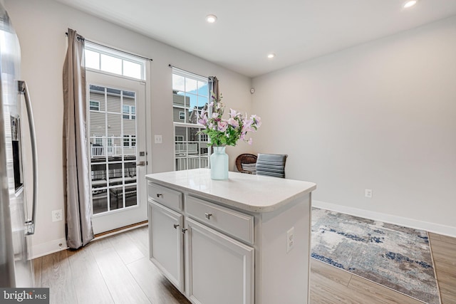 kitchen with a center island, light wood finished floors, and recessed lighting