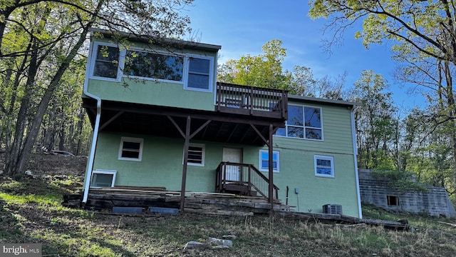view of front of property with a wooden deck and central AC