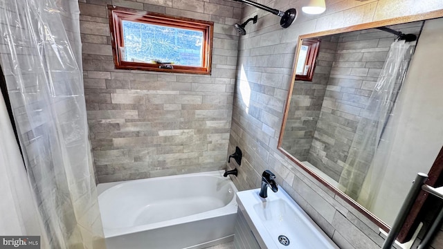 bathroom featuring shower / tub combo with curtain and tile walls