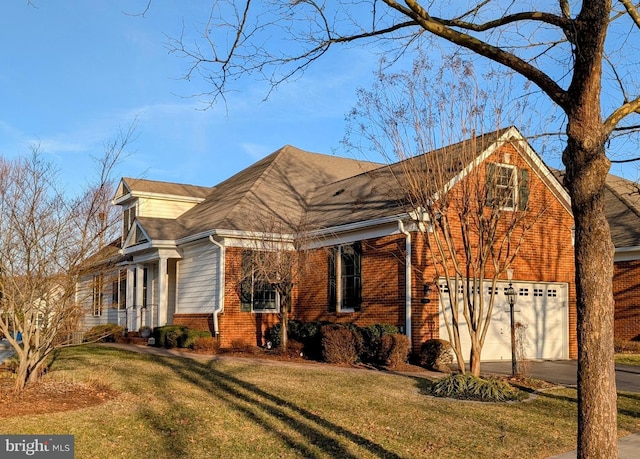 view of side of property featuring a yard, brick siding, and concrete driveway