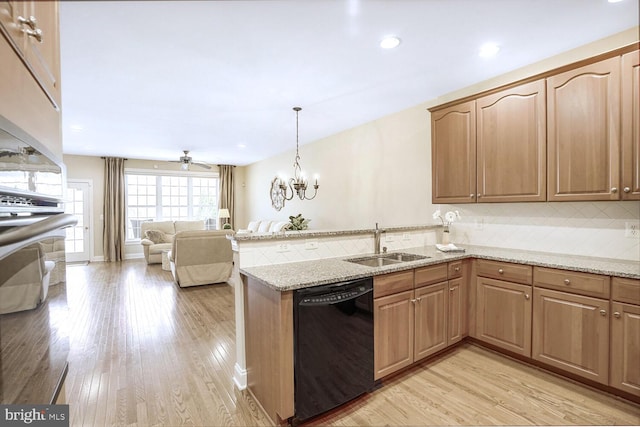 kitchen featuring light wood-style flooring, a peninsula, a sink, decorative backsplash, and dishwasher