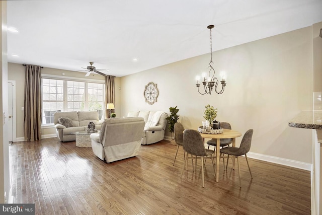 living room with recessed lighting, wood finished floors, and baseboards