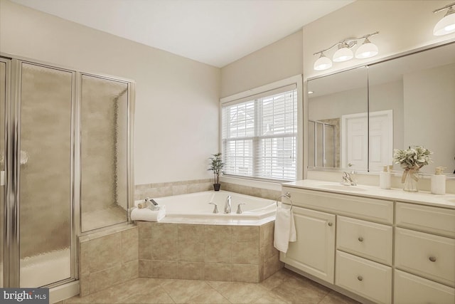 full bath featuring a garden tub, a shower stall, tile patterned flooring, and vanity