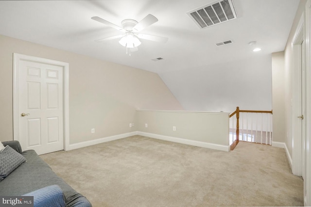 bonus room featuring lofted ceiling, baseboards, visible vents, and light colored carpet