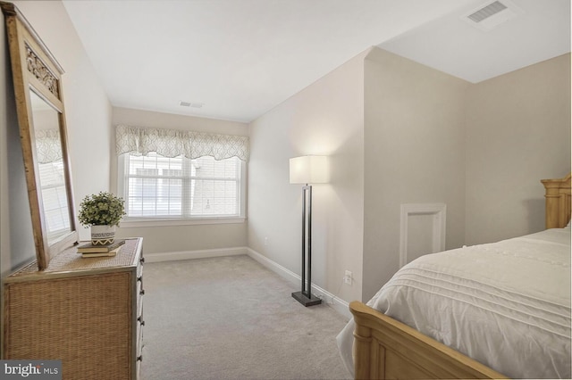 bedroom with light colored carpet, visible vents, and baseboards