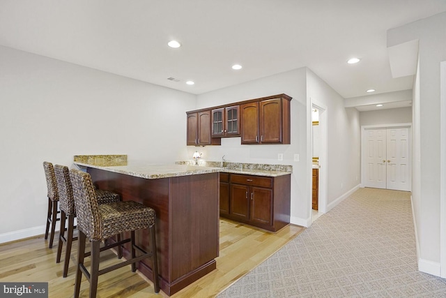 bar with light wood finished floors, baseboards, and recessed lighting