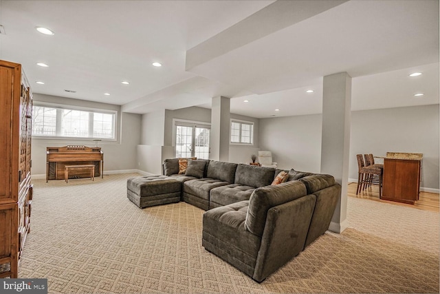 living area featuring recessed lighting, light colored carpet, and baseboards