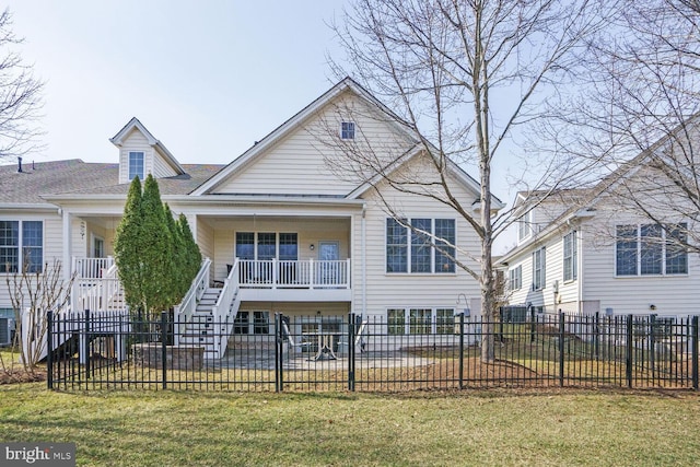 view of front of house with a patio, a fenced front yard, central AC, stairway, and a front yard