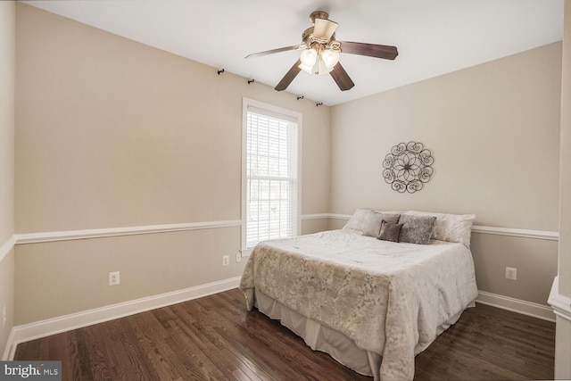 bedroom with ceiling fan, baseboards, and wood finished floors