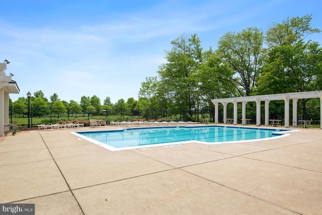 community pool featuring a patio, fence, and a pergola