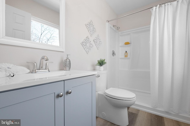 full bath featuring toilet, vanity, a shower with curtain, and wood finished floors