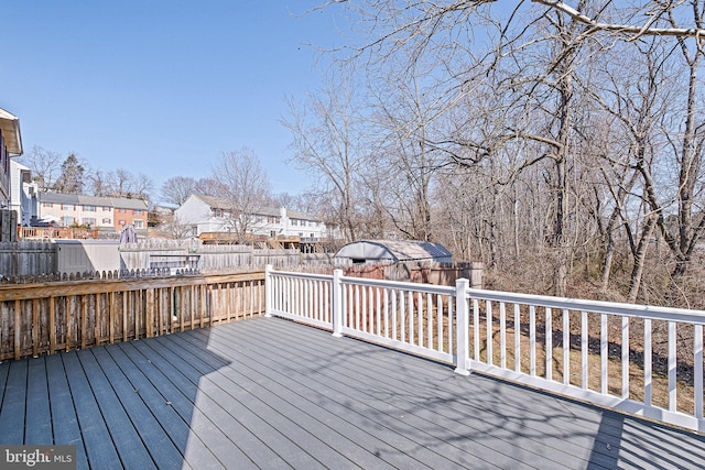 wooden deck with a residential view and a fenced backyard