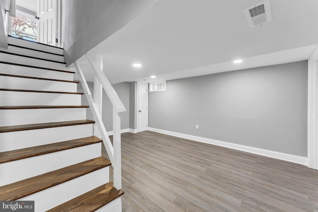 basement with baseboards, visible vents, stairway, wood finished floors, and recessed lighting