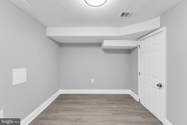 interior space with visible vents, baseboards, and wood finished floors