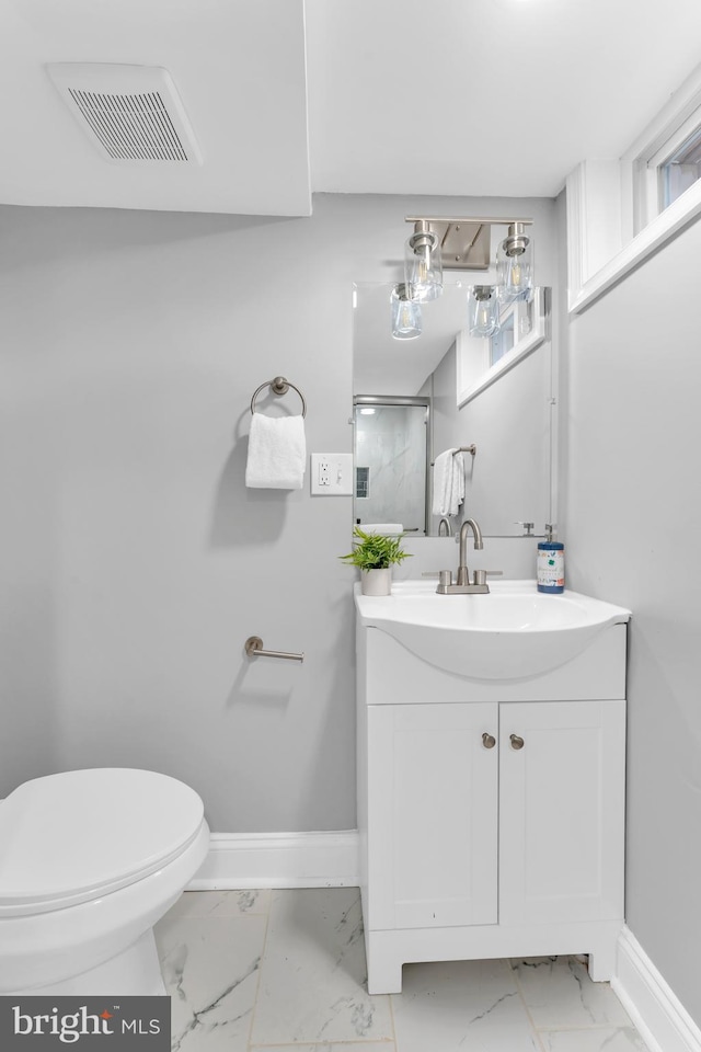 bathroom featuring marble finish floor, visible vents, vanity, and baseboards