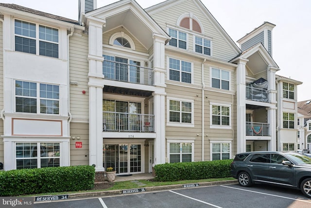 view of building exterior featuring uncovered parking