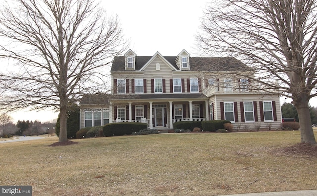 view of front of property with a front yard and covered porch