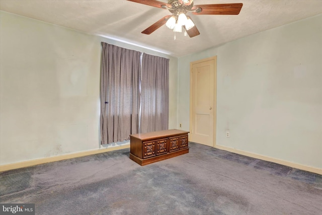 empty room featuring a ceiling fan, carpet, and baseboards