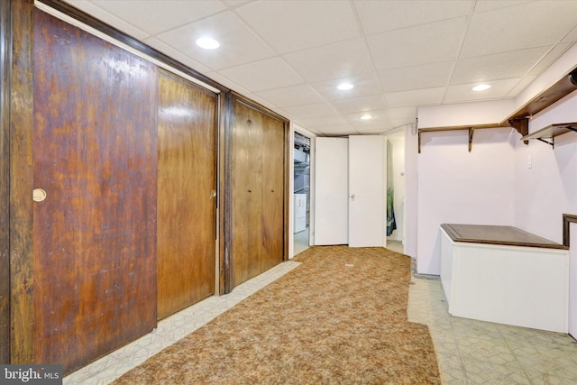 hall featuring recessed lighting, a paneled ceiling, and light floors