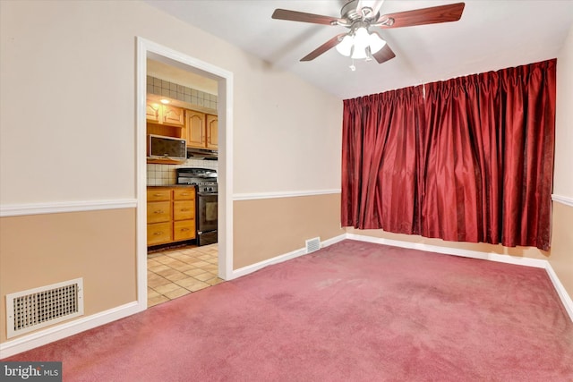 unfurnished room featuring ceiling fan, baseboards, visible vents, and light colored carpet