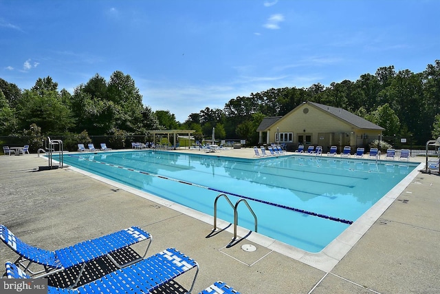 pool featuring a patio and fence