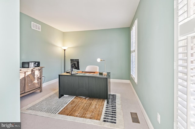 office featuring baseboards, visible vents, and carpet flooring