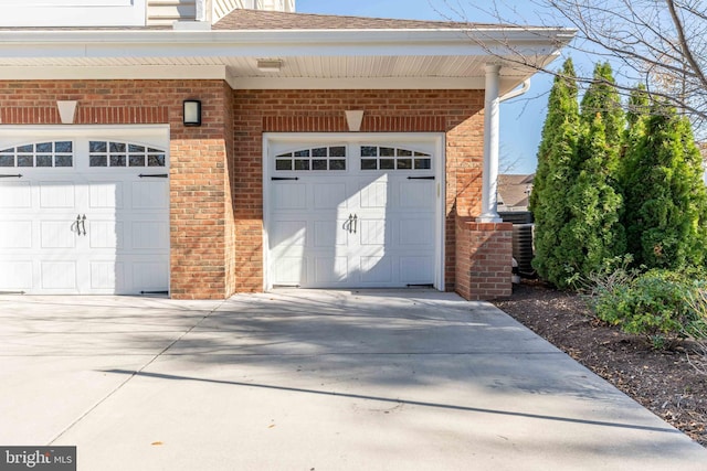 garage featuring concrete driveway