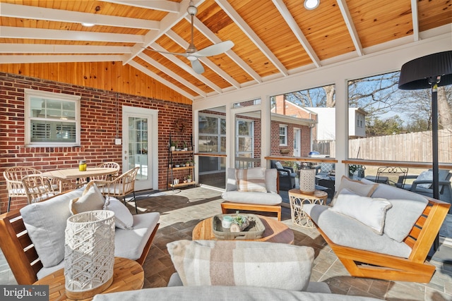 sunroom featuring vaulted ceiling with beams, wood ceiling, and a ceiling fan