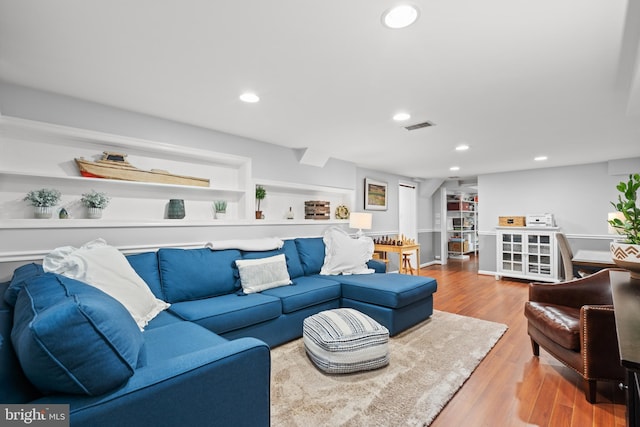 living room featuring recessed lighting, visible vents, and wood finished floors