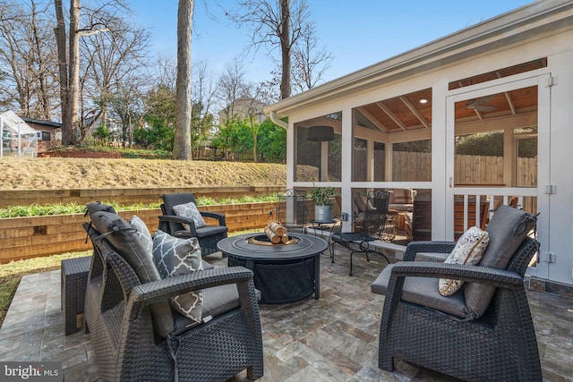 view of patio with fence and a sunroom