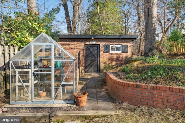 view of greenhouse with fence