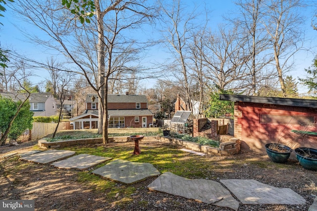 view of yard with fence and an outdoor structure