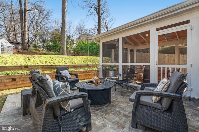 view of patio with fence and a sunroom