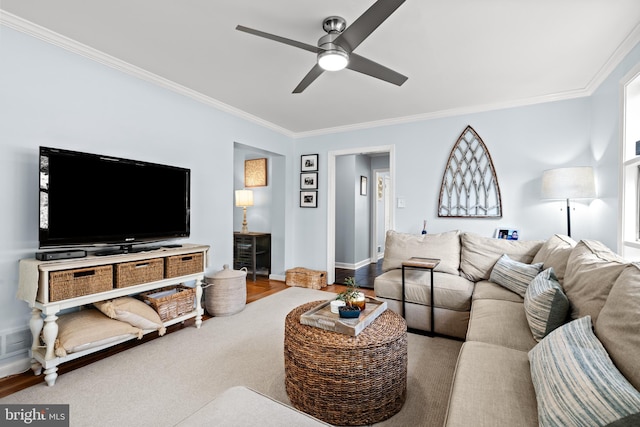 living area with ornamental molding, ceiling fan, and baseboards