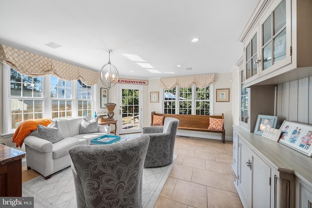 living area with light tile patterned floors, visible vents, baseboards, an inviting chandelier, and recessed lighting