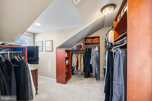 spacious closet with carpet floors and vaulted ceiling